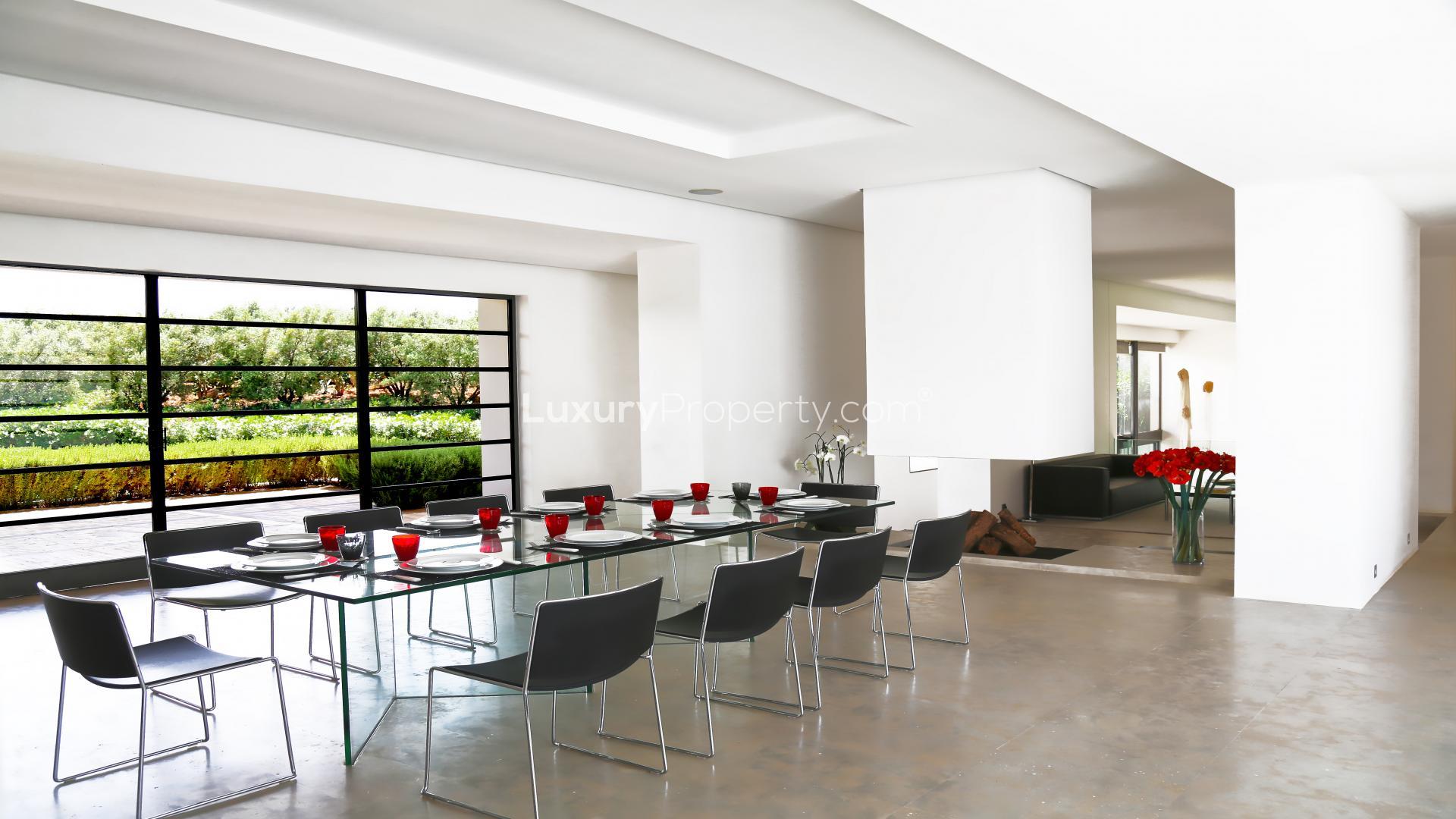 Contemporary Marrakech villa living room with modern art and large windows, Route de Lourika