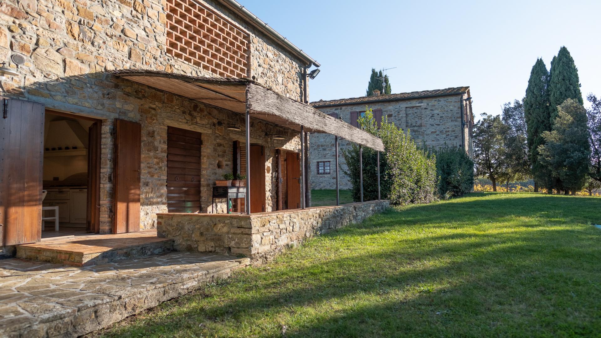 Rustic stone villa exterior in Tenuta Chianti Classico, Florence, for sale