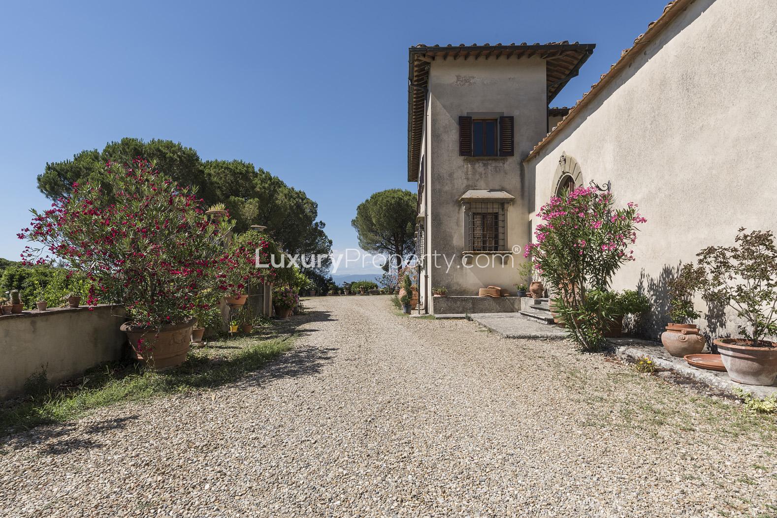 Exterior of 14th Century Villa Belvedere in Florence with rustic door and potted plants