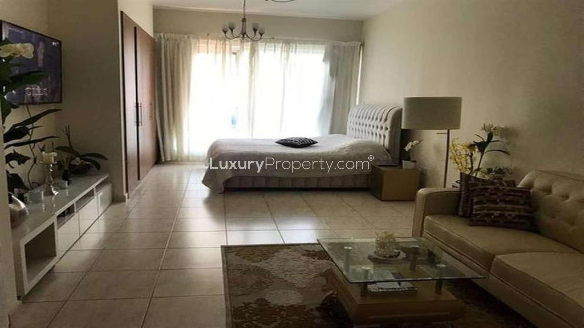 Spacious studio apartment living area in Skycourt Towers, Dubailand, with modern furnishings