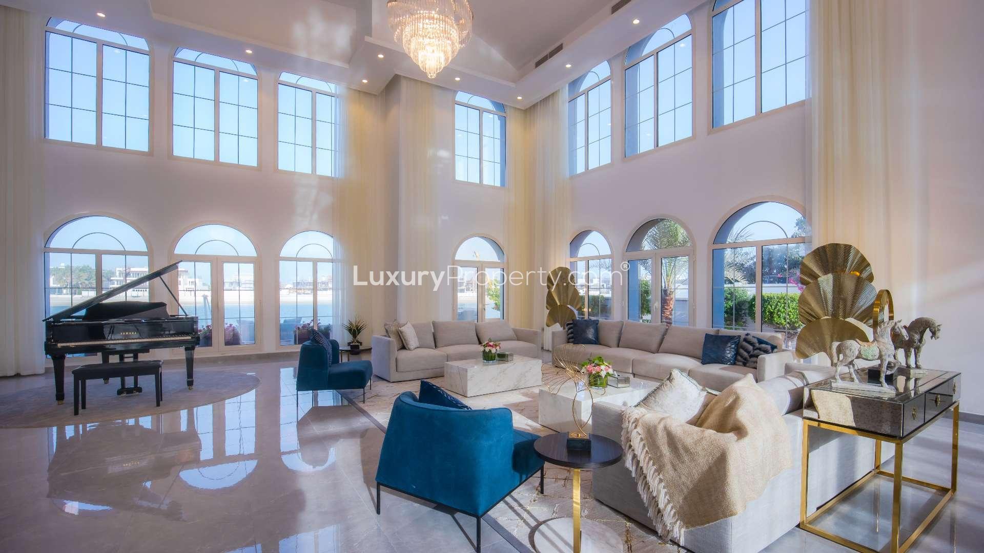 Luxurious living room in fully furnished Palm Jumeirah villa with grand piano and chandeliers