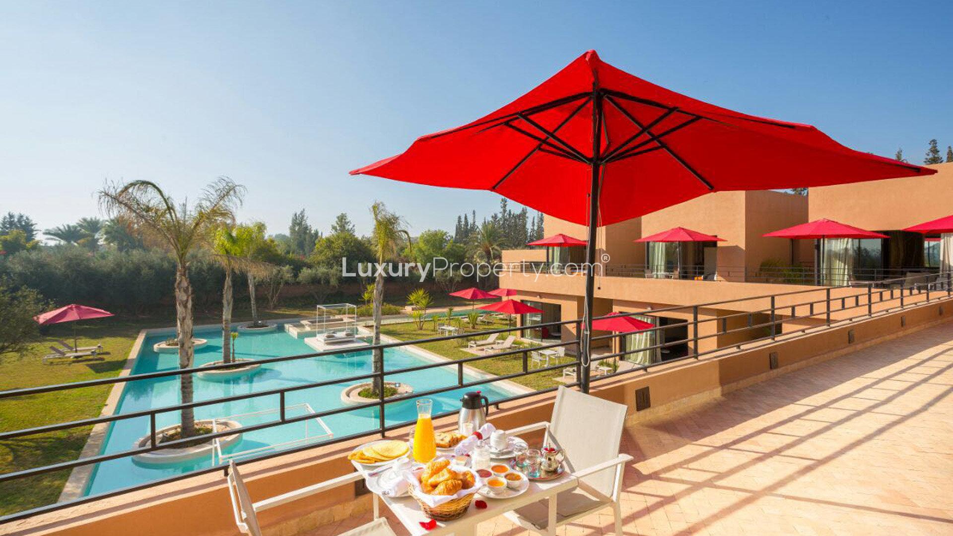 Luxurious Villa Surya in Marrakech with poolside patio and red umbrellas