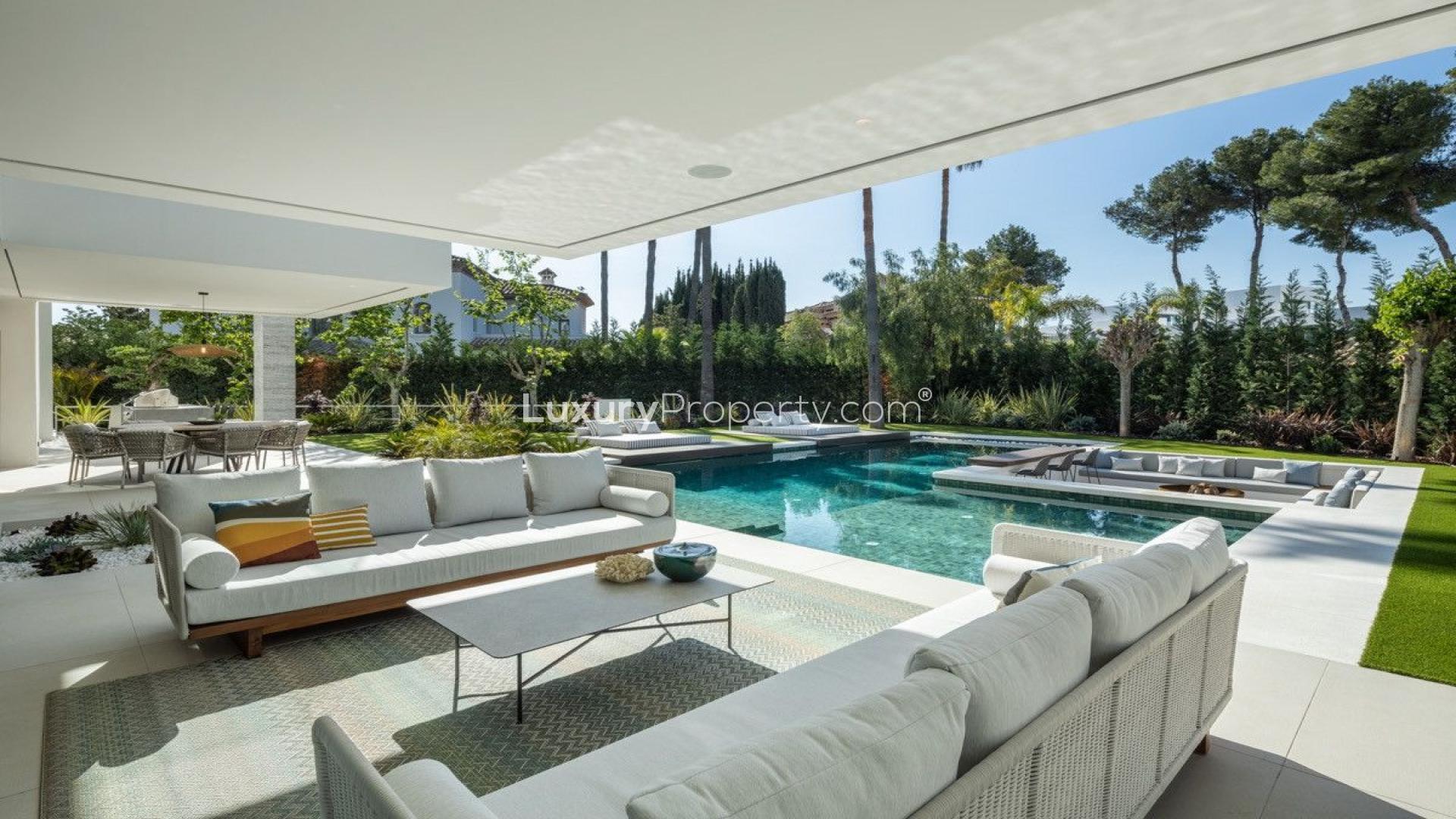 Outdoor seating area overlooking pool in luxury villa, Atalaya Rio Verde, Marbella