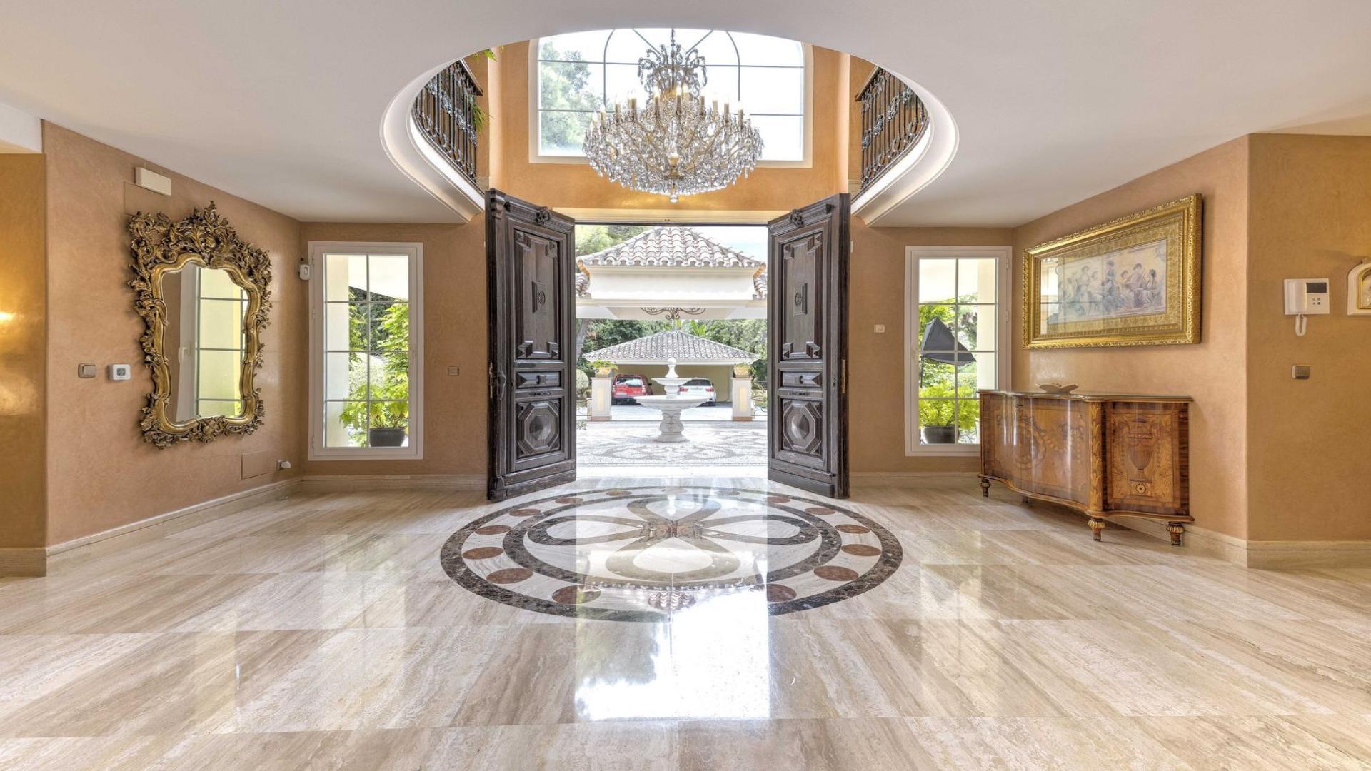 Luxurious living room in Sierra Blanca 6-bedroom villa, featuring elegant decor and fireplace