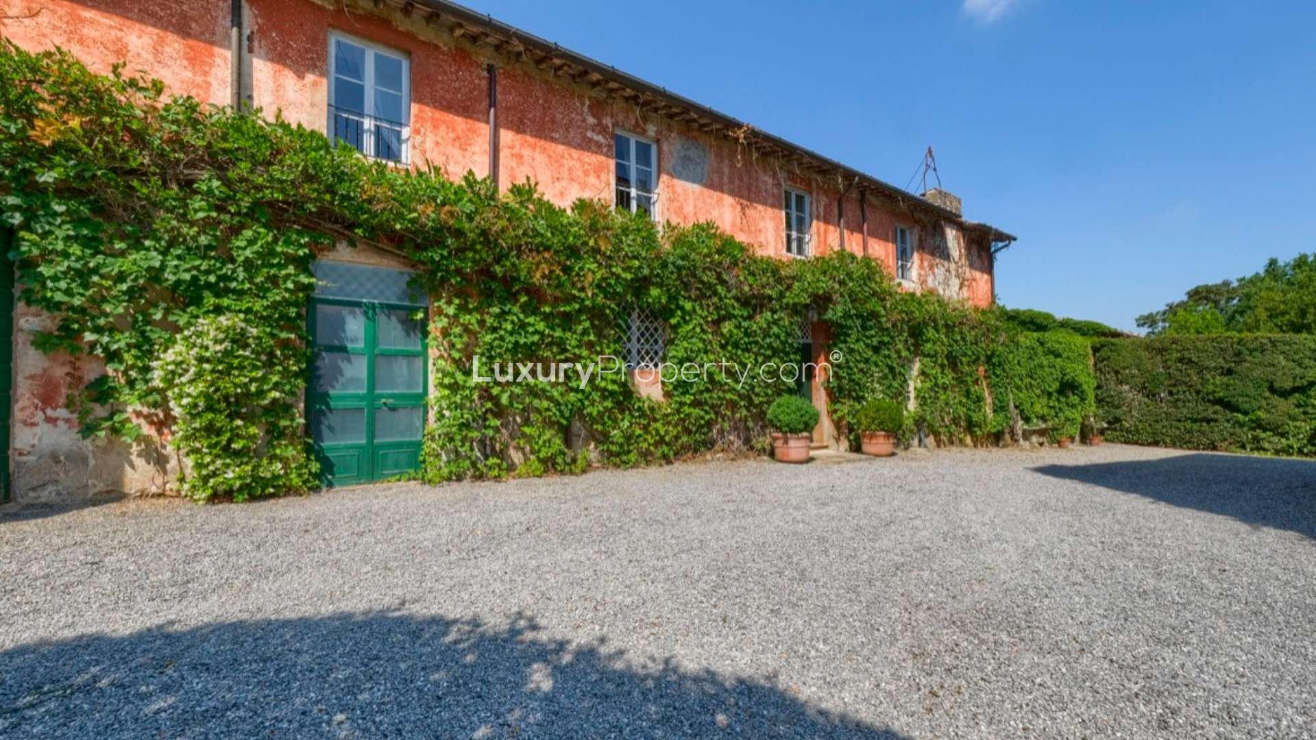 Exterior view of Lucca Aristocratic Manor villa with ivy-covered walls for sale