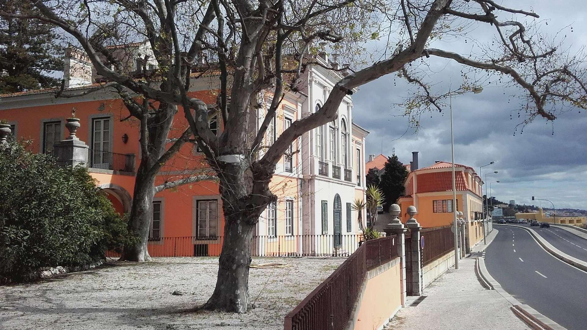 Neoclassical palace villa exterior with ocean view in Paço de Arcos, Portugal