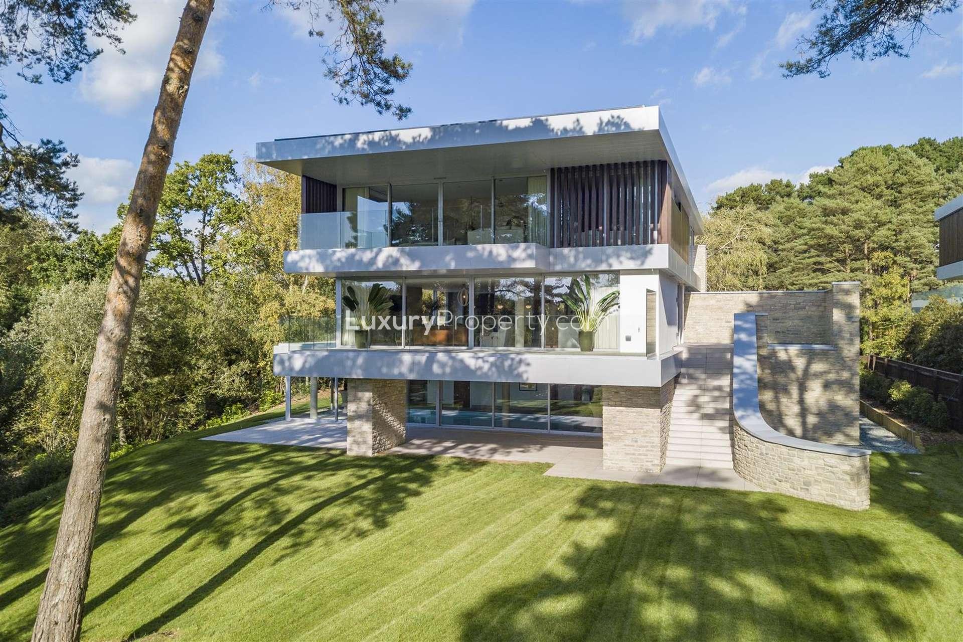 Modern 12-bedroom Luscombe Estate villa exterior with lush lawn, for sale in Sandbanks, Dorset