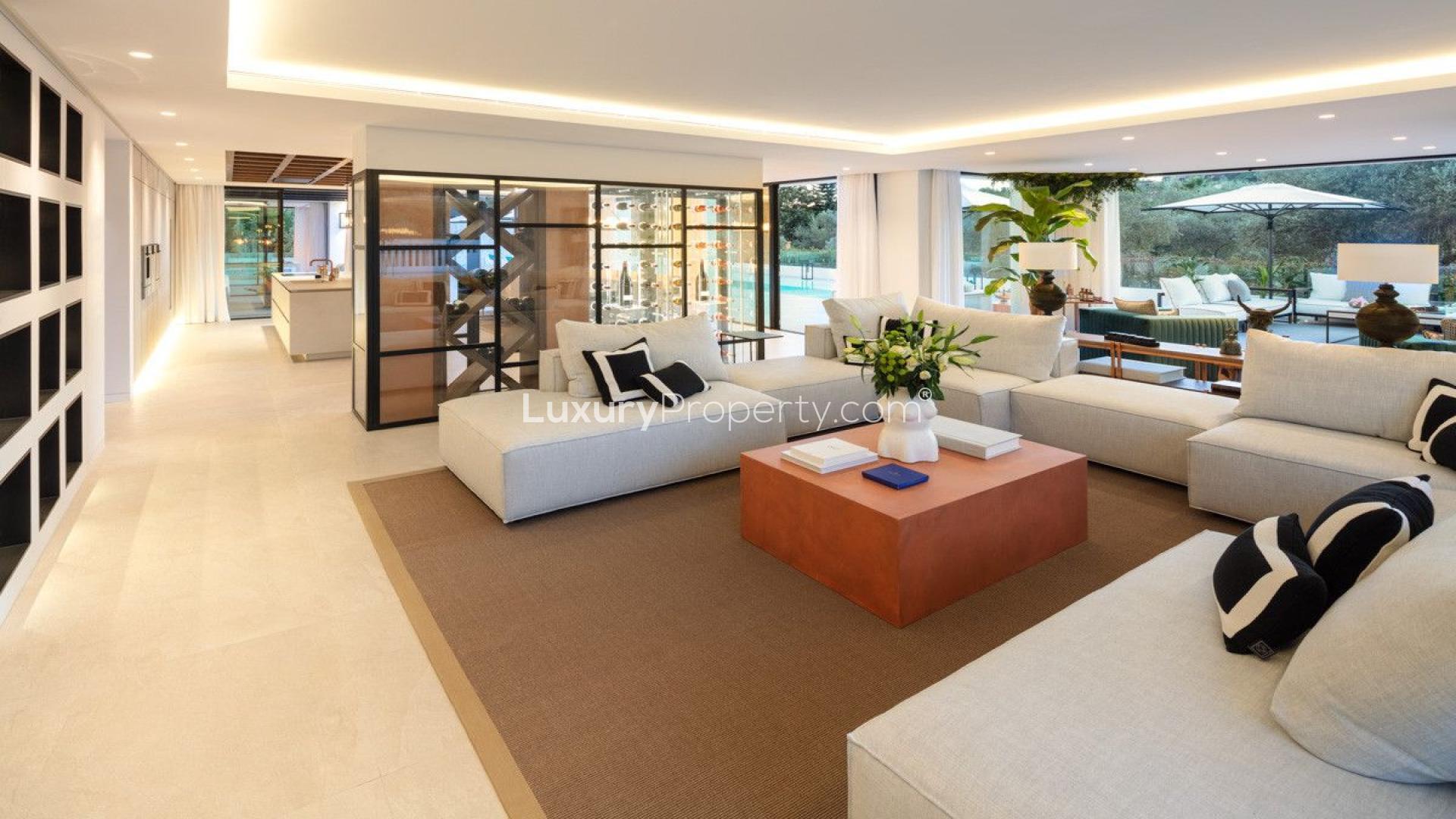 Modern living room in 5-bedroom golf villa, Las Brisas, Marbella, with fireplace and wine display