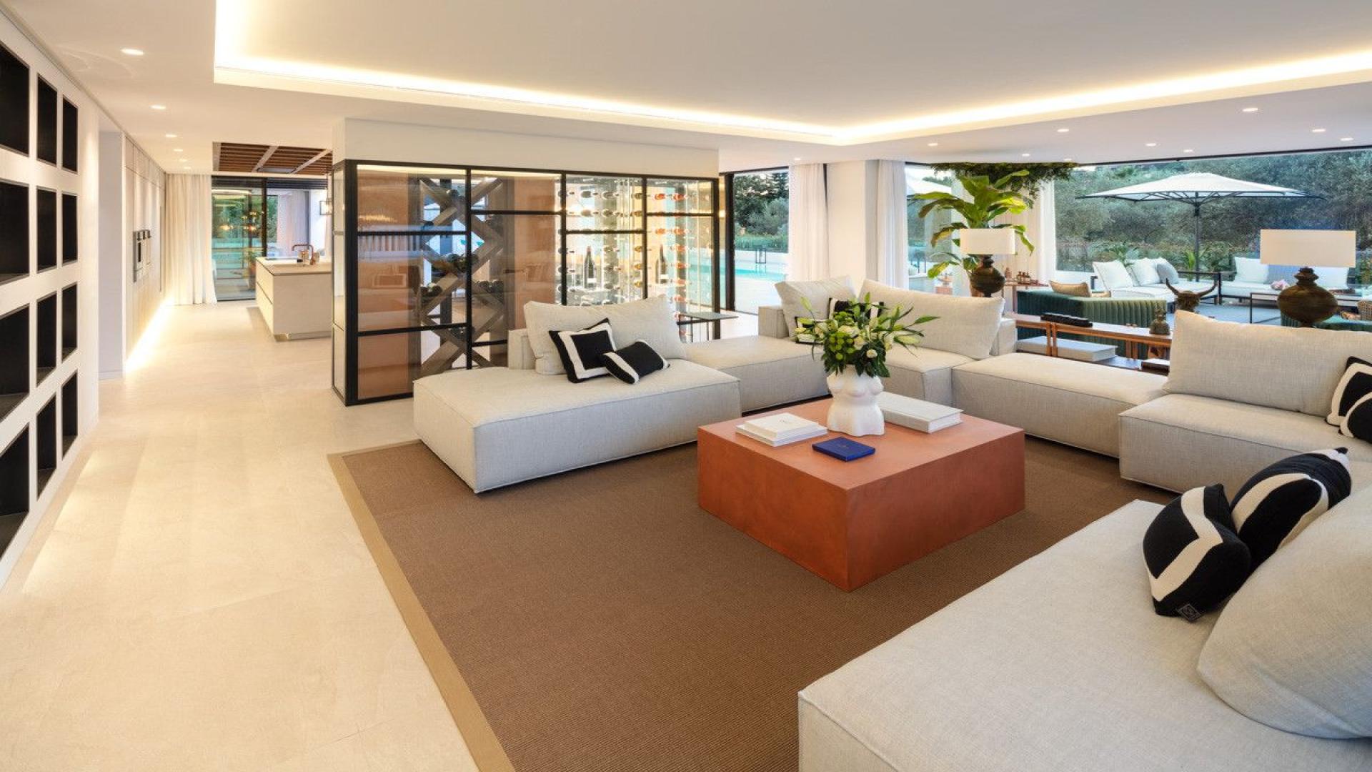 Modern living room in 5-bedroom golf villa, Las Brisas, Marbella, with fireplace and wine display