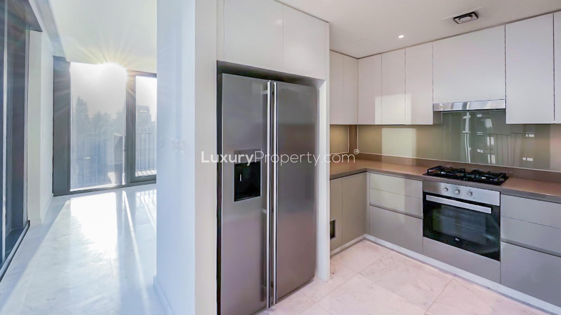 Modern kitchen in Downtown Dubai apartment, high floor, bright sunlight, sleek appliances, BLVD Heights