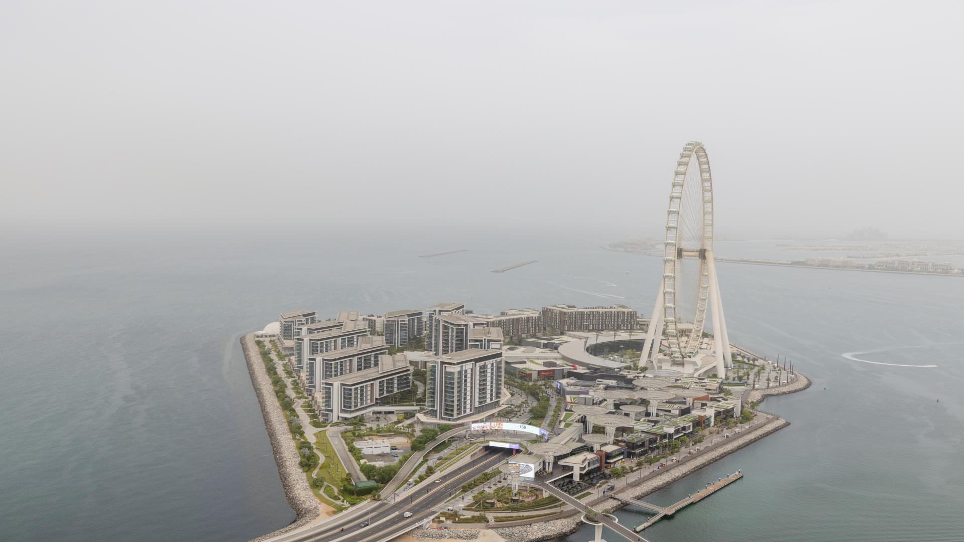 Modern living room in serviced apartment, Jumeirah Beach Residence, with elegant decor and plush seating
