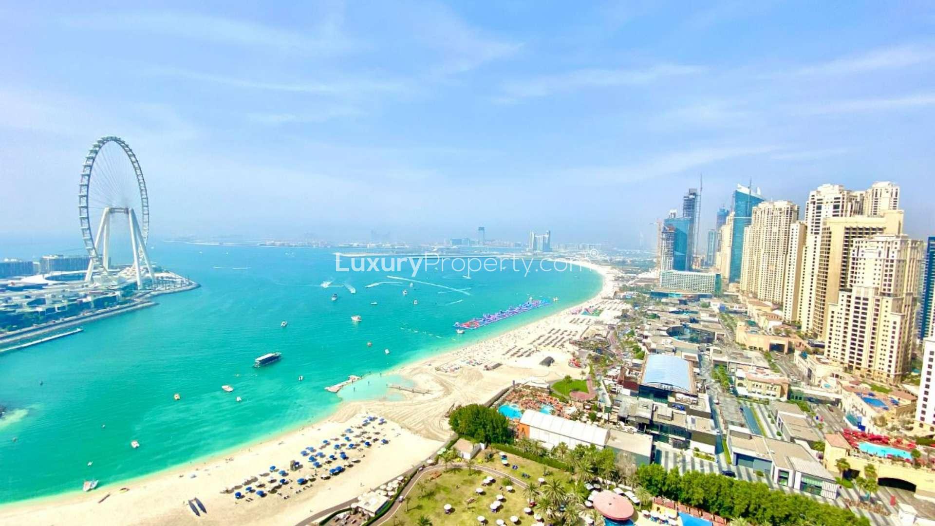 Empty room with large windows showcasing stunning sea and skyline view at Al Bateen Residences