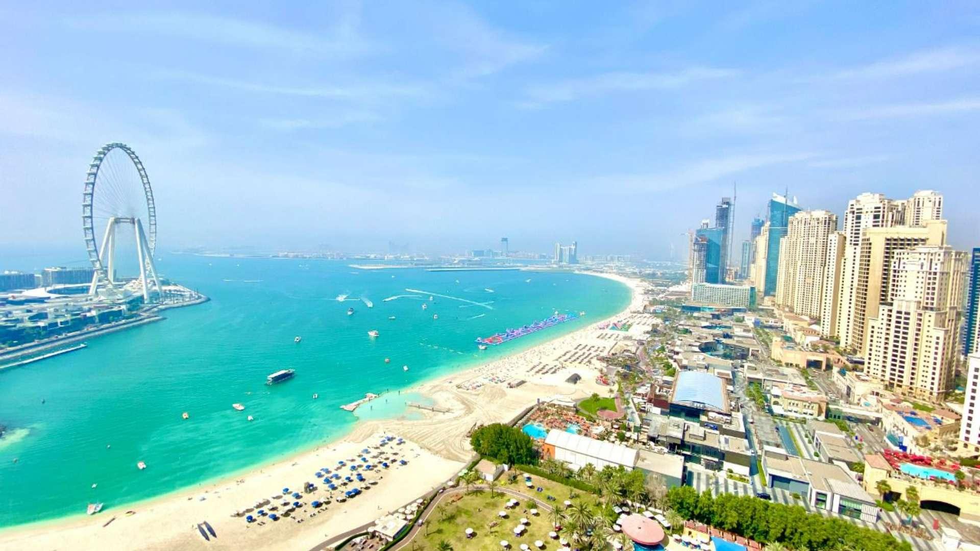 Empty room with large windows showcasing stunning sea and skyline view at Al Bateen Residences