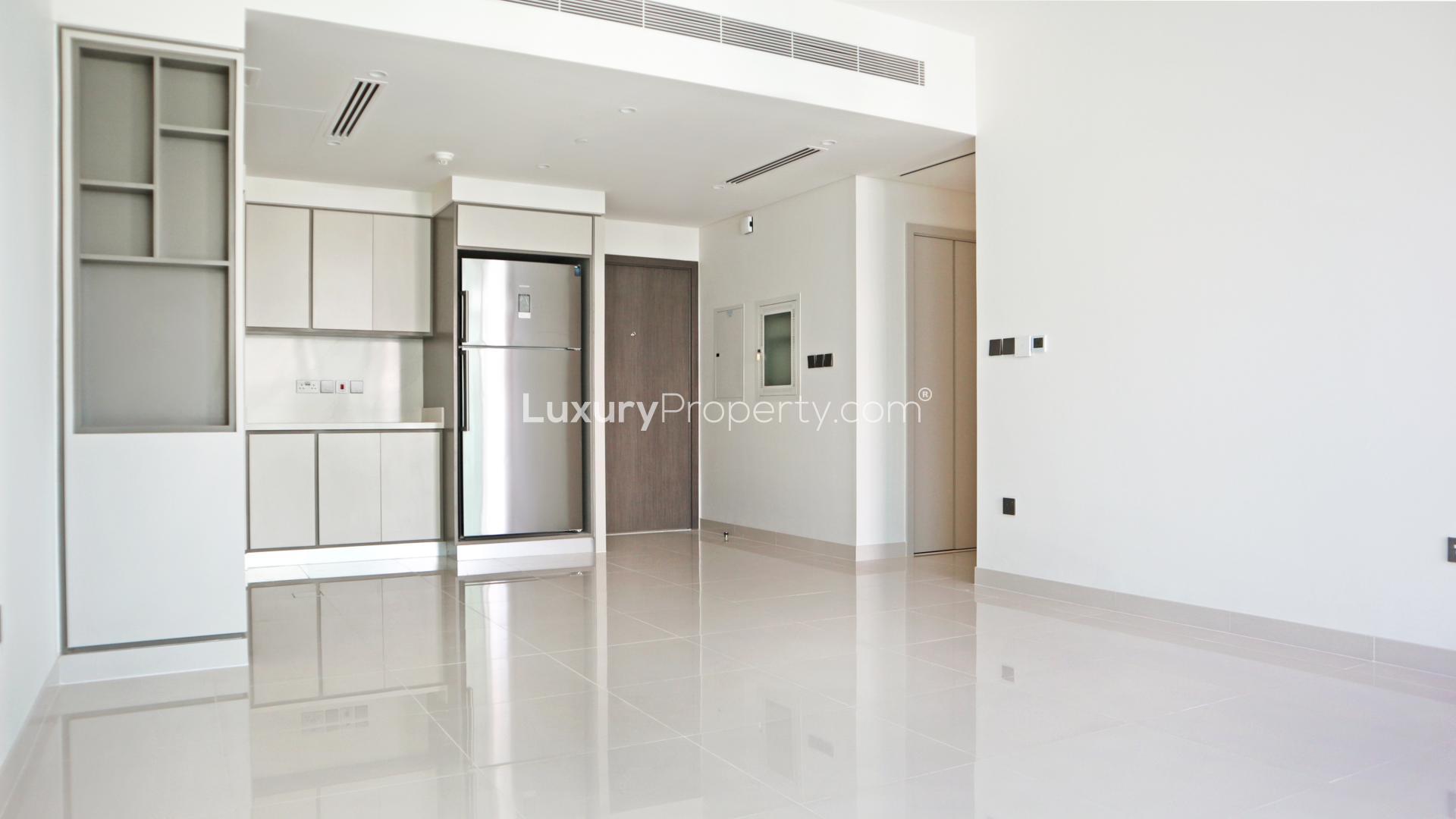 "Bright living area in beachfront apartment, Emaar Beachfront, Dubai Harbour, with modern finishes.",Modern kitchen in fully furnished two-bedroom apartment, Emaar Beachfront, Dubai Harbour