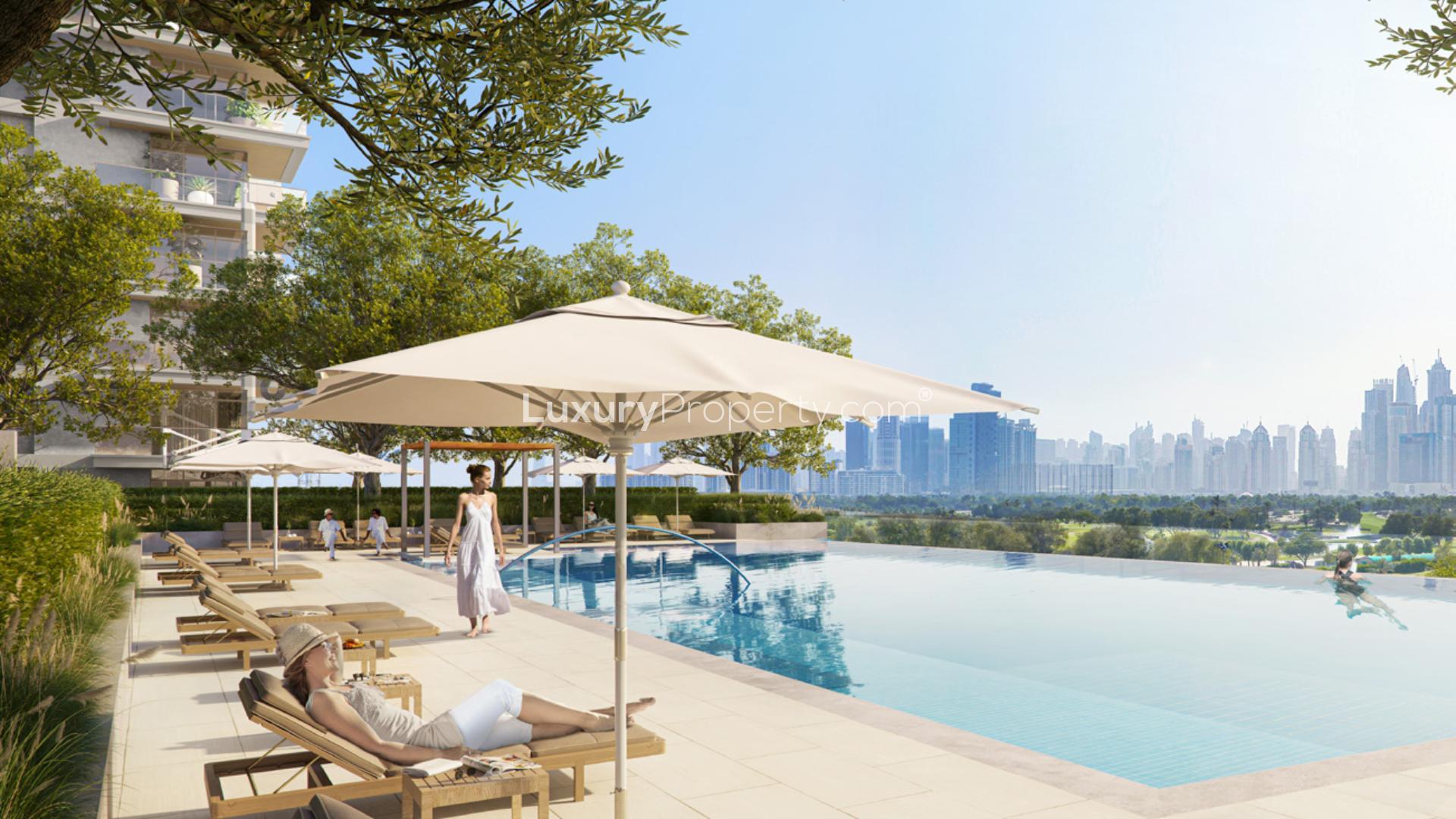 "Stylish Golf Heights apartment exterior at dusk, Emirates Living community, two-bedroom re-sale.",Infinity pool with city skyline view at Golf Heights, Emirates Living apartment complex