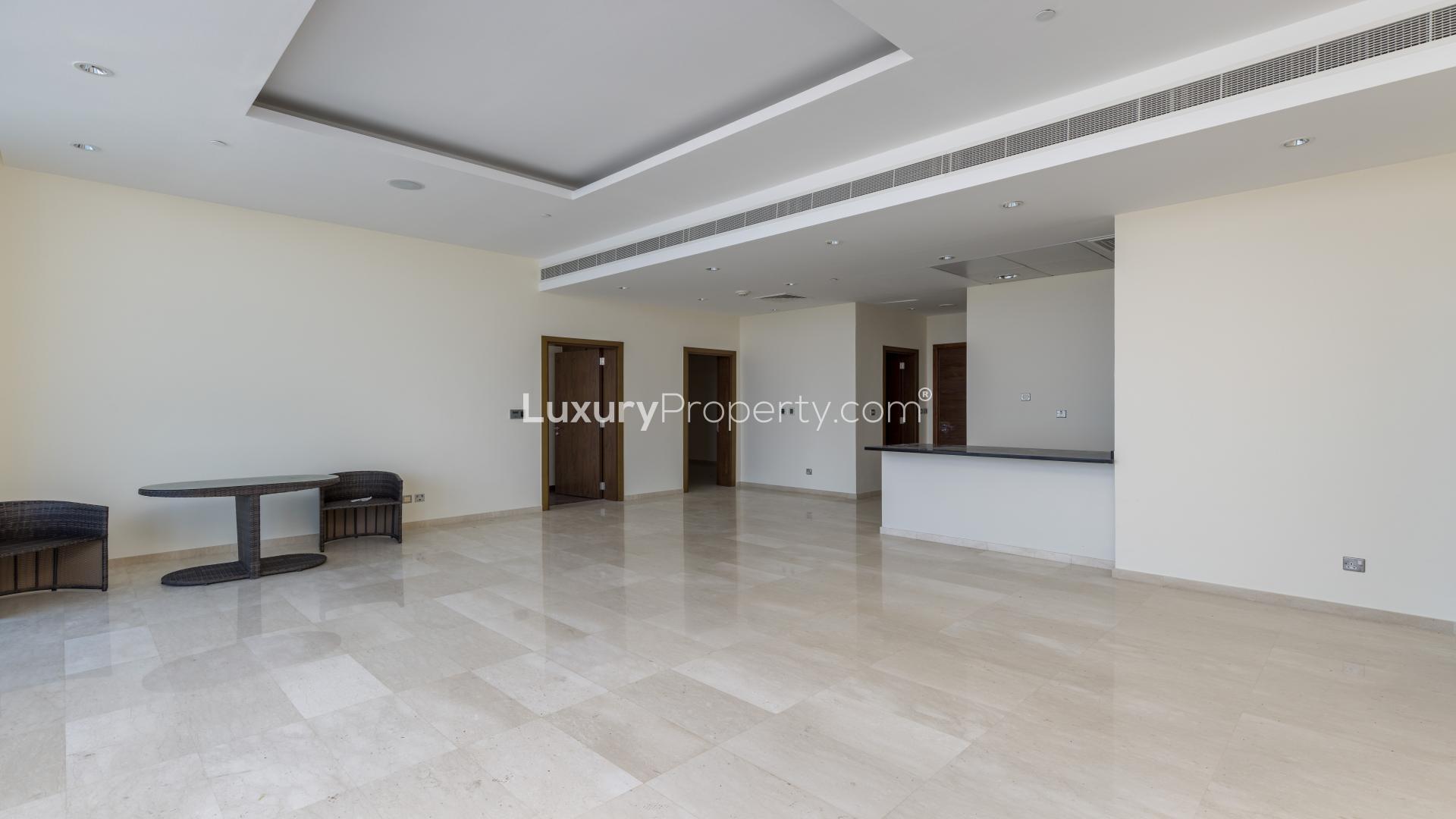 "Stunning Palm Jumeirah apartment balcony with panoramic sea and city skyline views.",Spacious living area in Oceana apartment for sale, Palm Jumeirah, with modern finishes