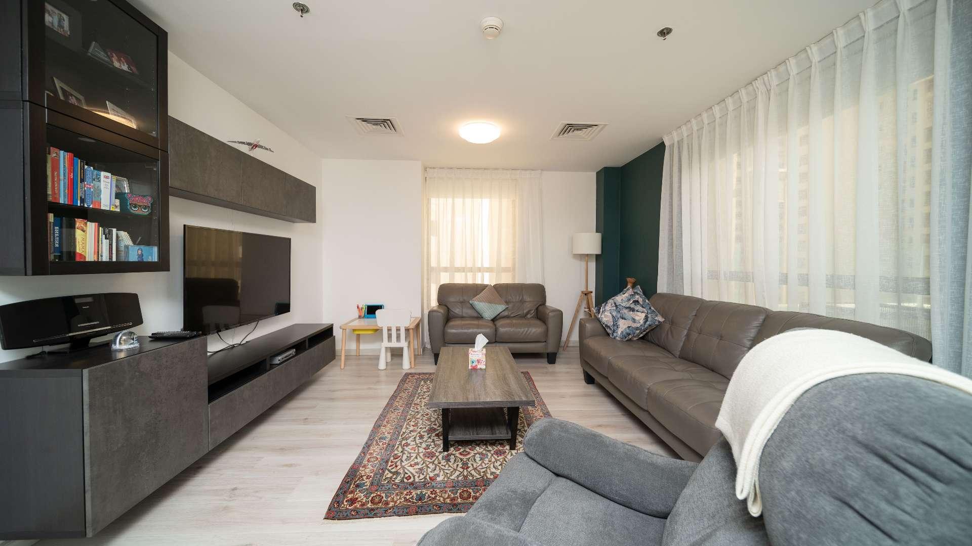 "Spacious terrace with lounge chairs in furnished Jumeirah Beach Residence apartment for sale.",Furnished dining area and kitchen in upgraded Jumeirah Beach Residence apartment, Shams community