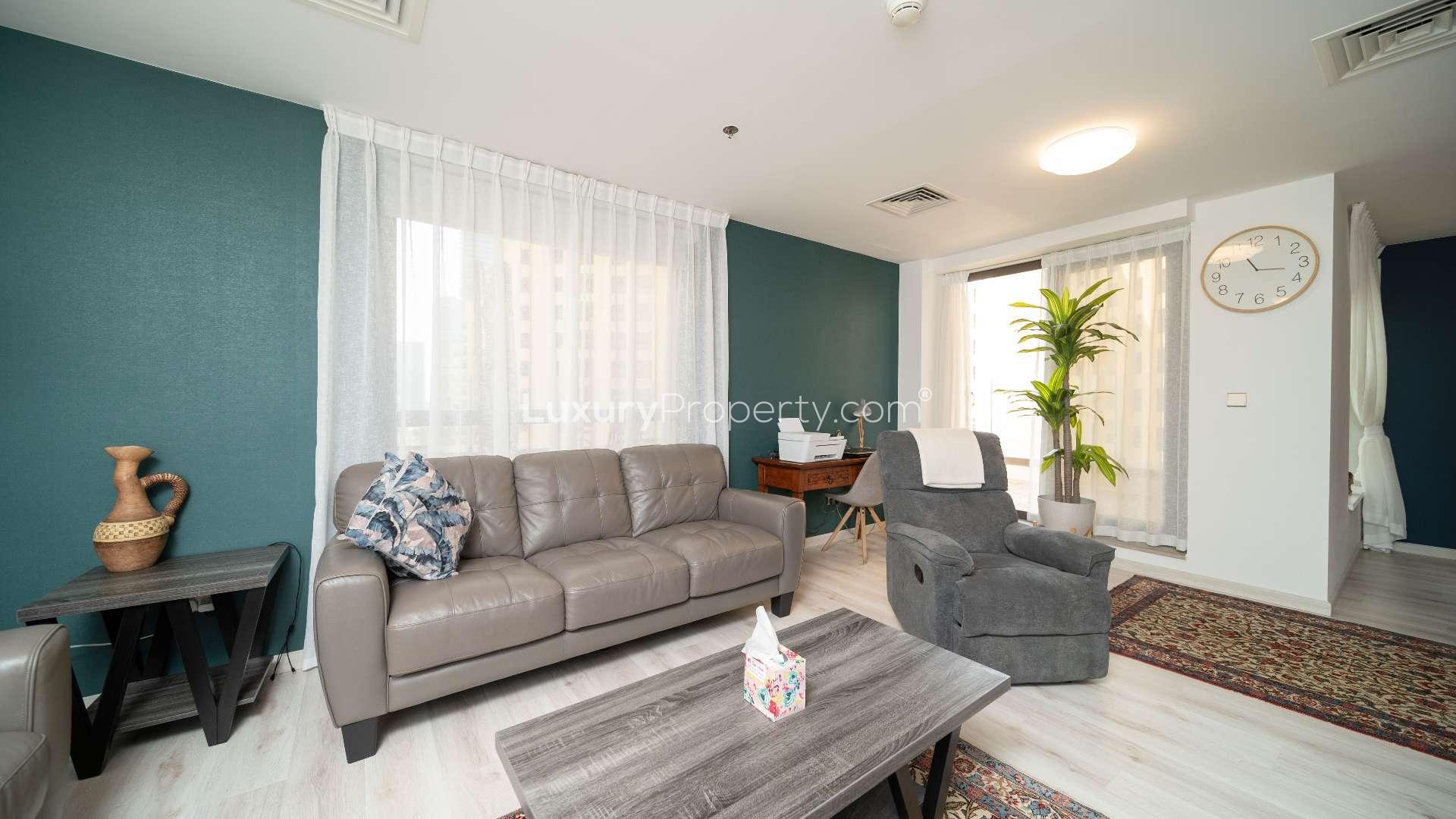 Furnished living room with modern decor and large terrace in Jumeirah Beach Residence apartment