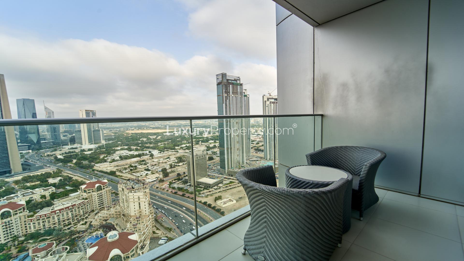 "Elegant dining area in high-floor apartment with city views, Downtown Dubai, The Address BLVD.",High floor apartment balcony with Downtown Dubai skyline view, The Address The BLVD