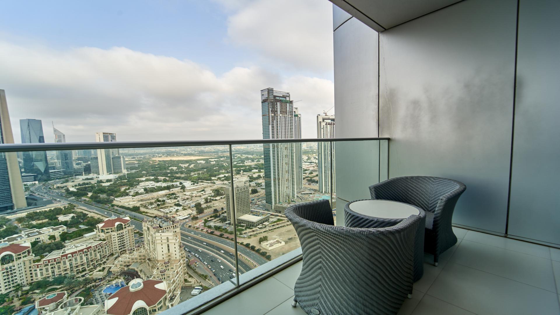 "Elegant dining area in high-floor apartment with city views, Downtown Dubai, The Address BLVD.",High floor apartment balcony with Downtown Dubai skyline view, The Address The BLVD