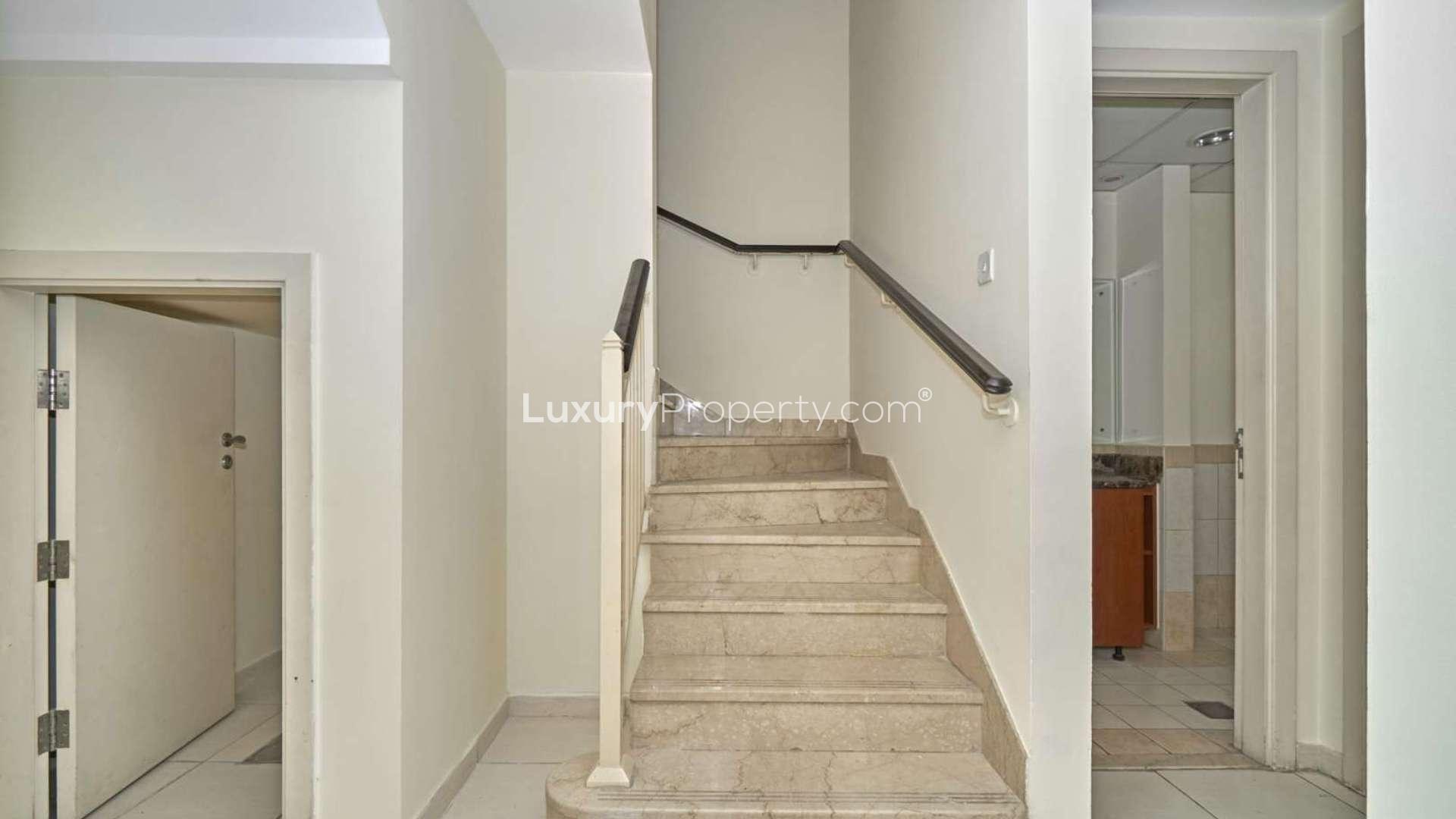 Modern kitchen in 2-bedroom villa, Springs 7, featuring sleek cabinetry and tiled backsplash