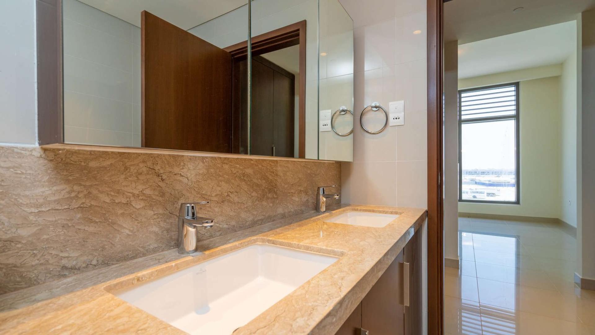 Spacious living room with floor-to-ceiling windows in Dubai Hills Estate apartment