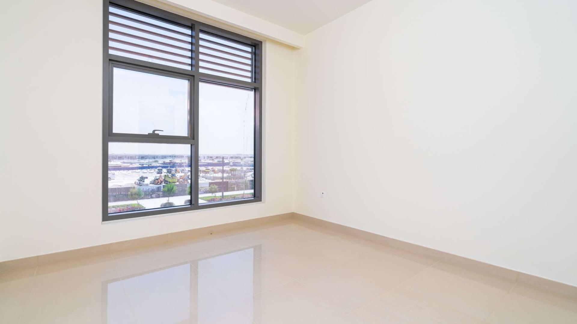 "Spacious balcony view of park and pool, 2-bedroom apartment, Dubai Hills Estate.",Empty room with large window, park view in Dubai Hills Estate apartment for rent
