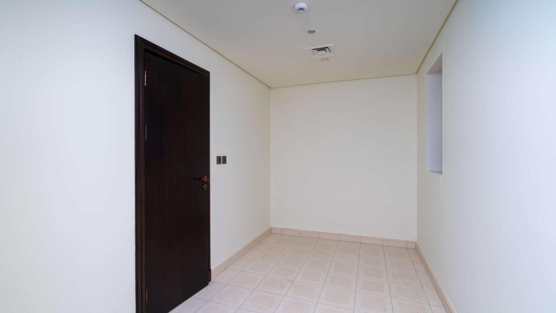 "Bright living room with sea view at Balqis Residence, Palm Jumeirah apartment for rent.",Minimalist hallway in Balqis Residence apartment, Palm Jumeirah, featuring dark wooden door