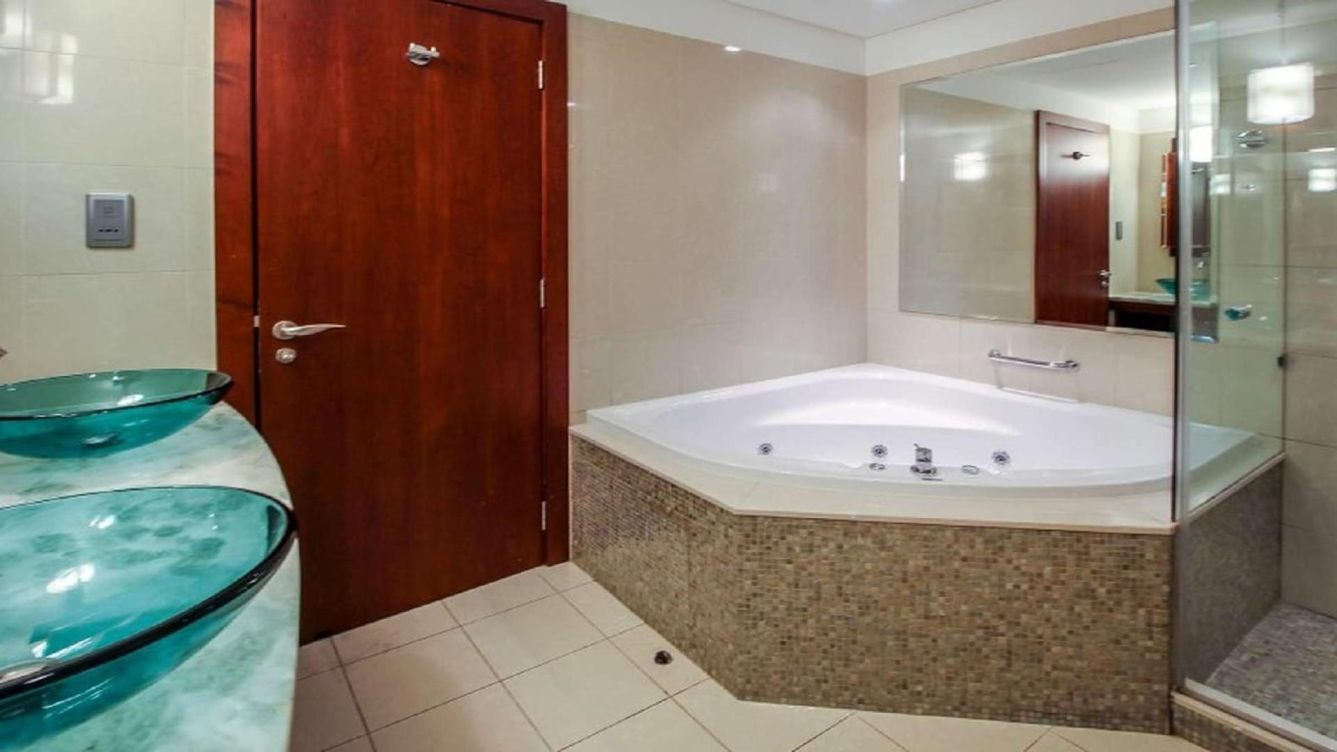 Spacious living area with large windows in Jumeirah Living apartment, World Trade Centre Residence