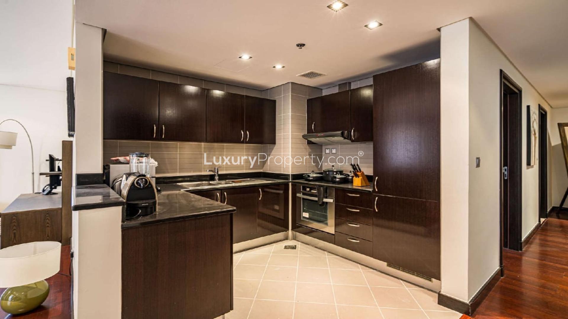 Modern kitchen with dark wood cabinets in Palm Jumeirah two-bedroom apartment for rent