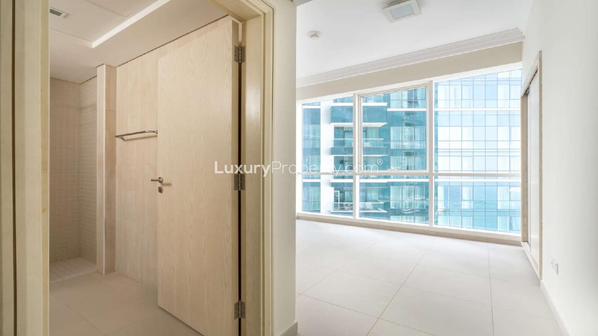 Empty living room with large windows in Jumeirah Beach Residence apartment for rent