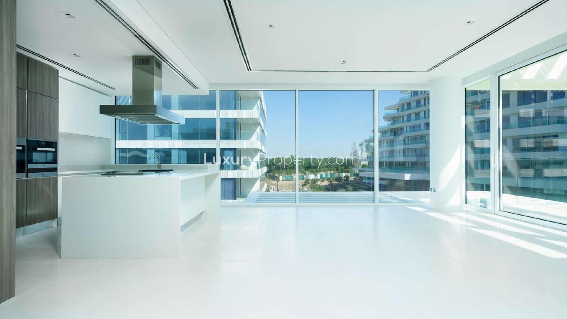 Spacious living area in 2-bedroom Ashjar apartment, Al Barari, with modern kitchen design