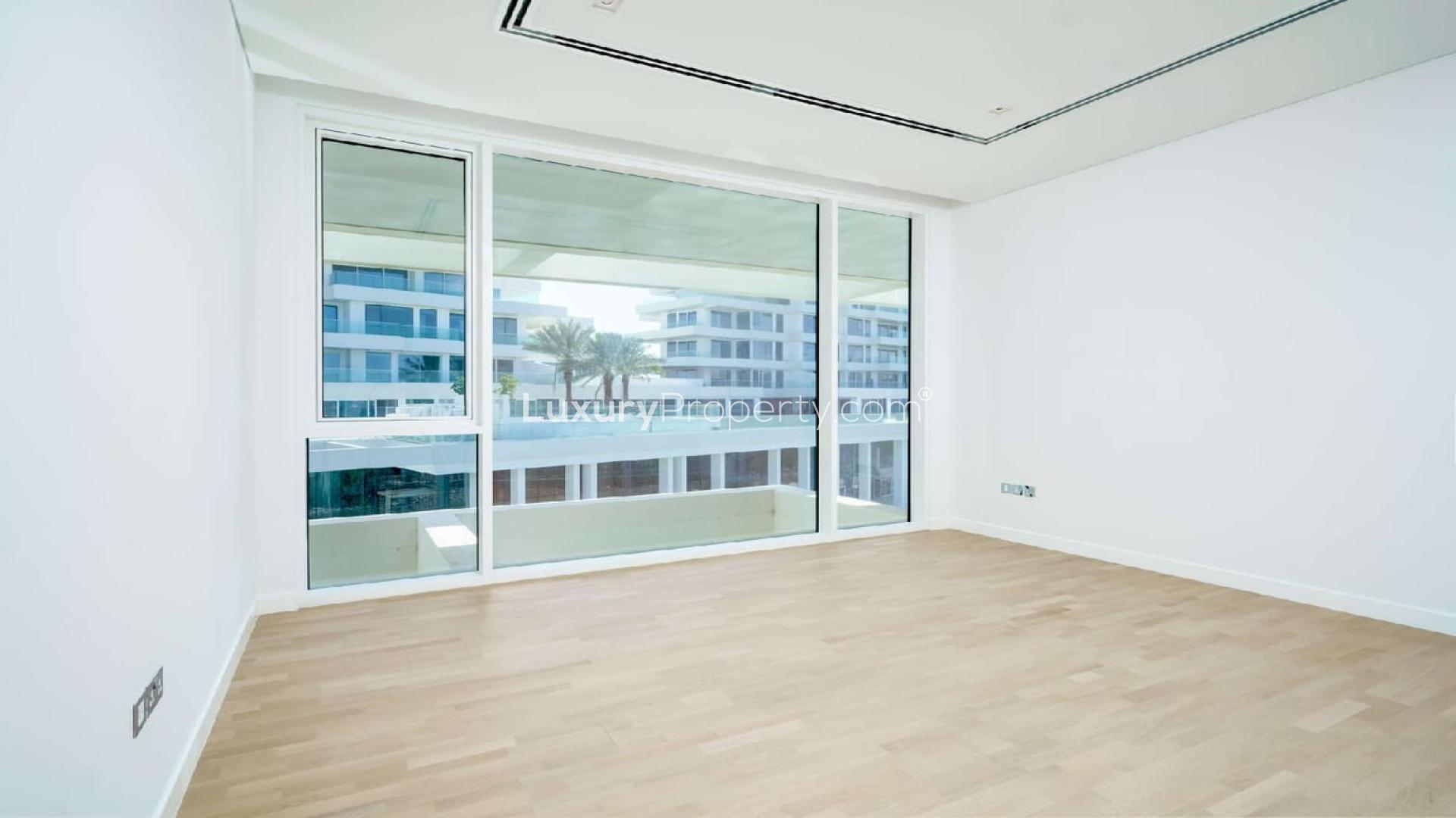 Modern apartment building in lush Ashjar, Al Barari, with landscaped pathways and greenery