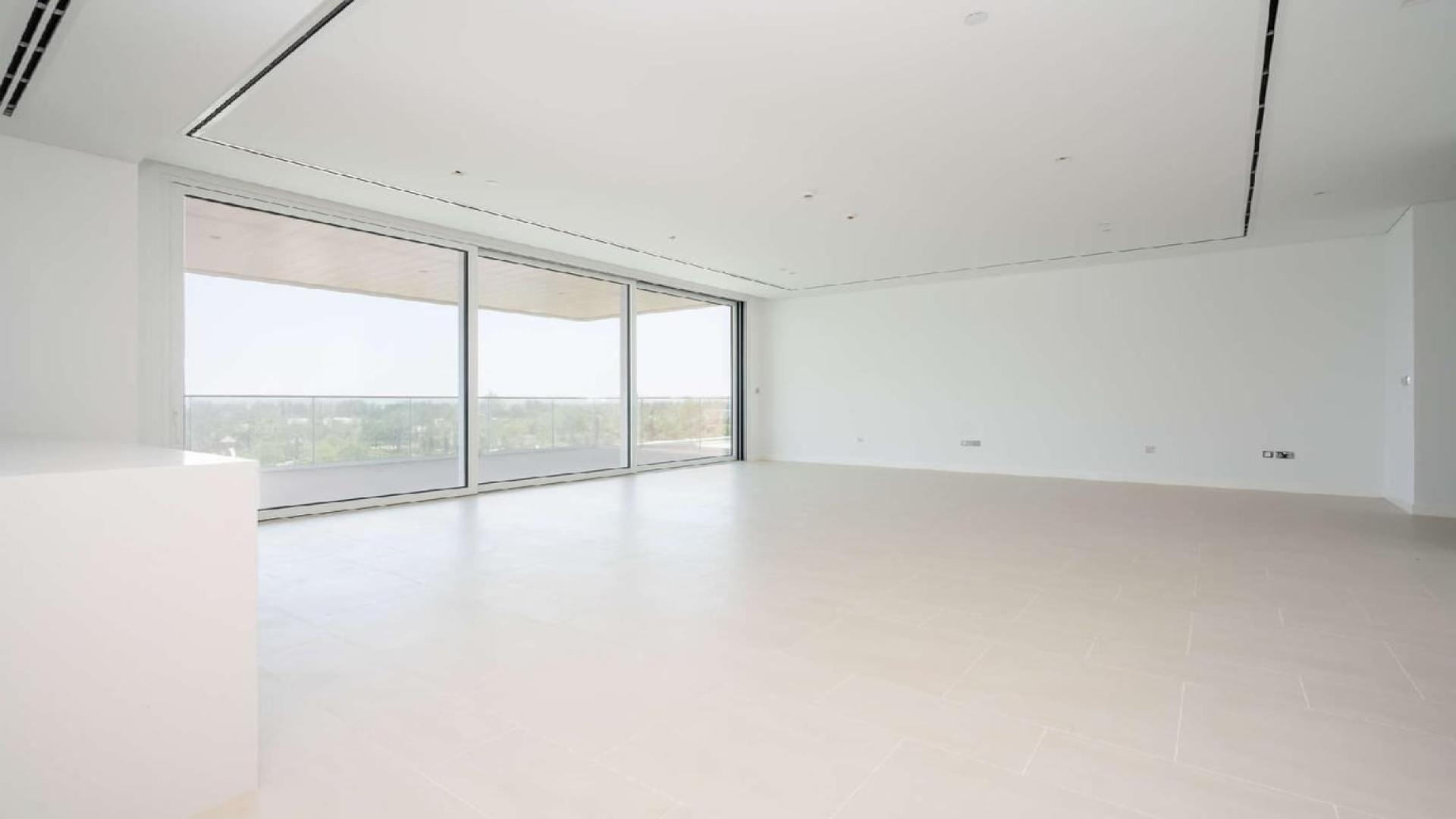 Modern open-plan living area in Seventh Heaven, Al Barari apartment with large windows