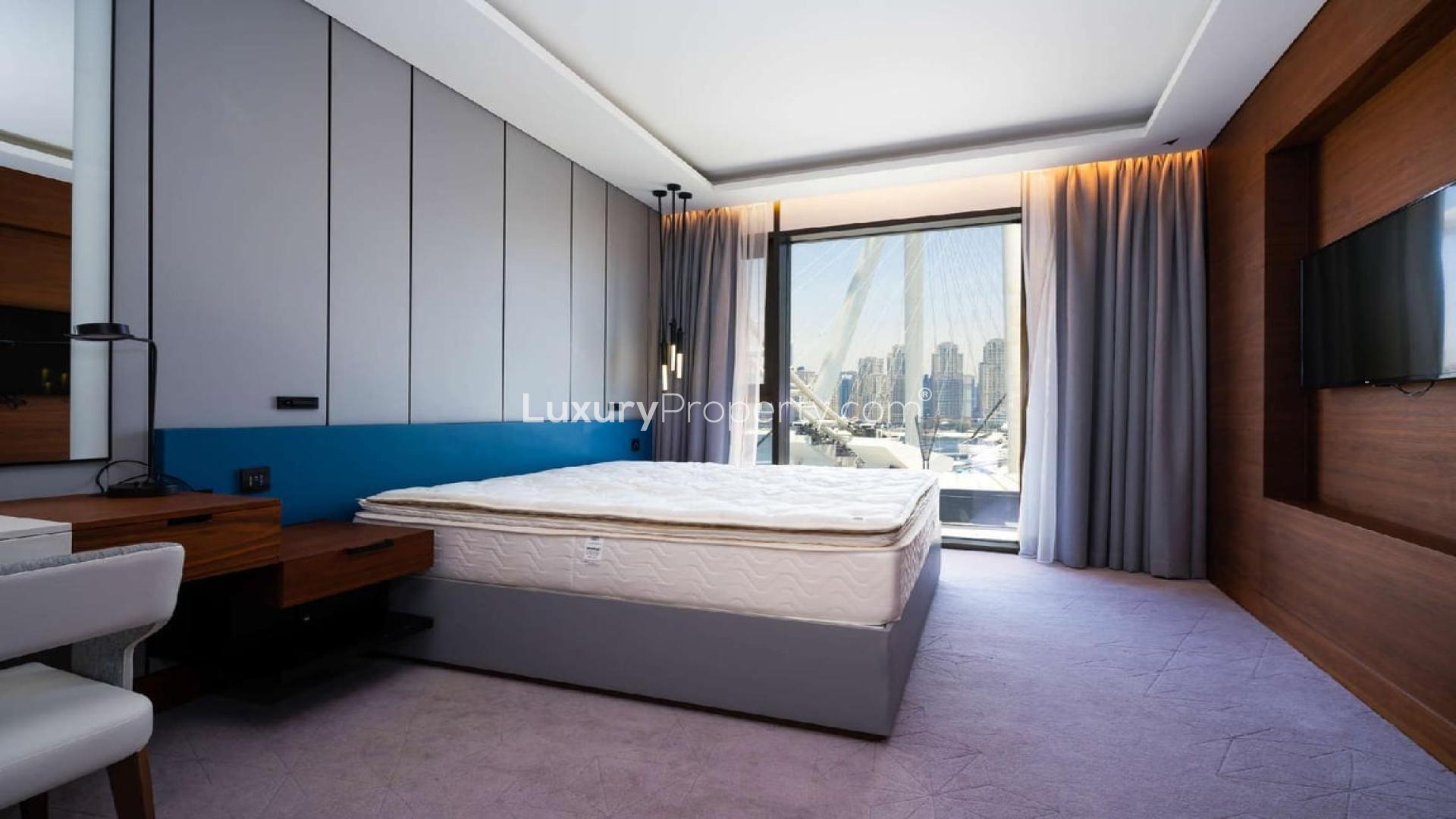 "View from two-bedroom apartment balcony at Caesars Resort, Bluewaters, Dubai skyline visible.",Luxurious bedroom with city view in two-bedroom apartment, Caesars Resort, Bluewaters, Dubai