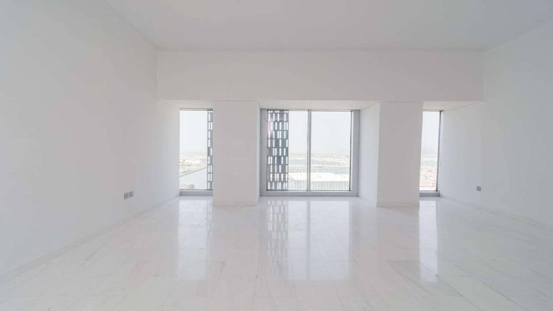 High-floor Dubai Marina apartment interior with large windows and partial sea view