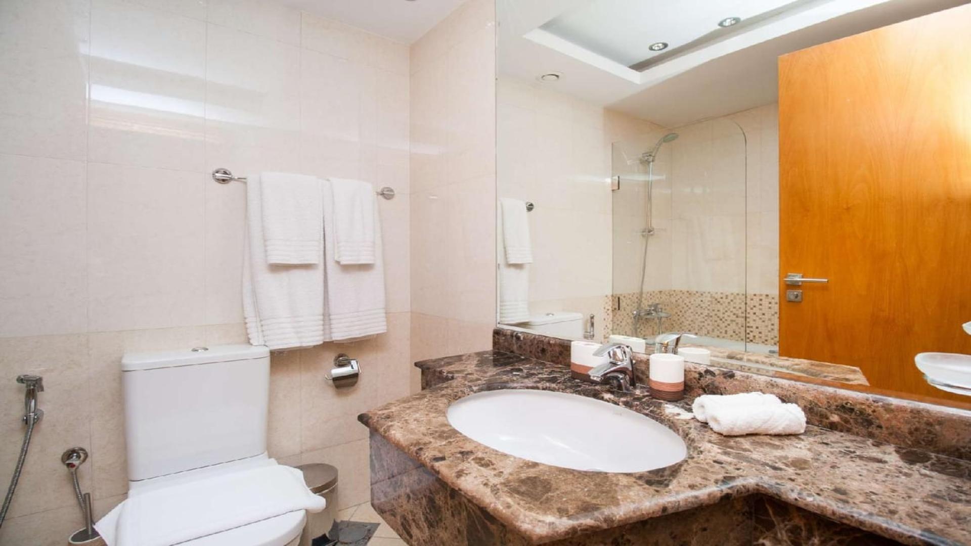 Modern bathroom in 2-bedroom apartment, Dorra Bay, Dubai Marina with marble countertop and amenities