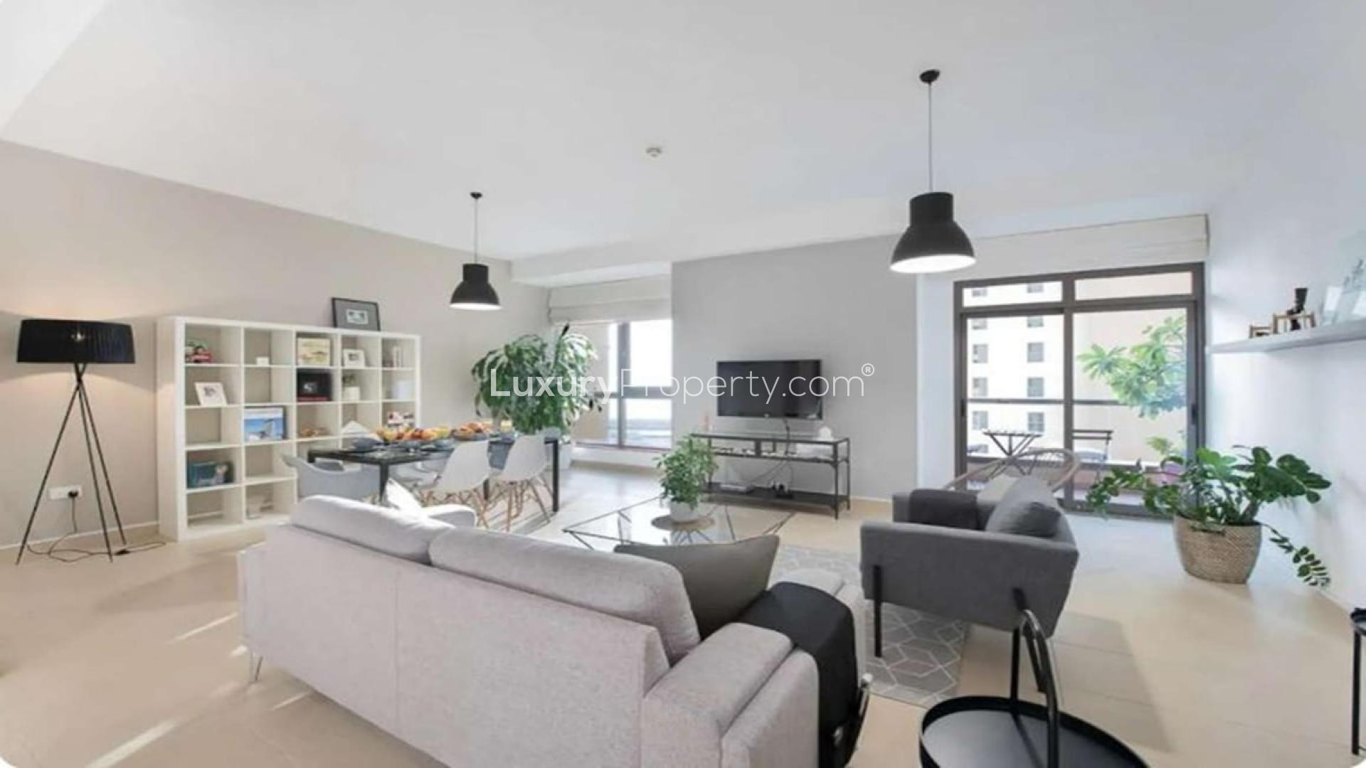 Stylishly furnished living area in 2-bedroom JBR apartment, featuring modern decor and open layout