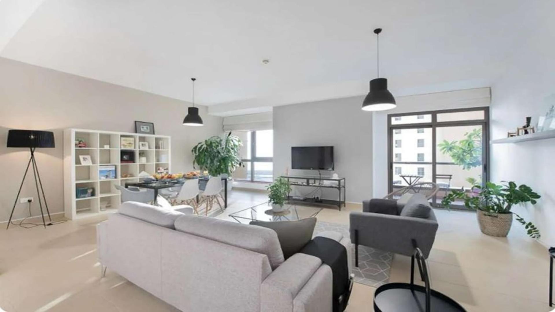 Stylishly furnished living area in 2-bedroom JBR apartment, featuring modern decor and open layout