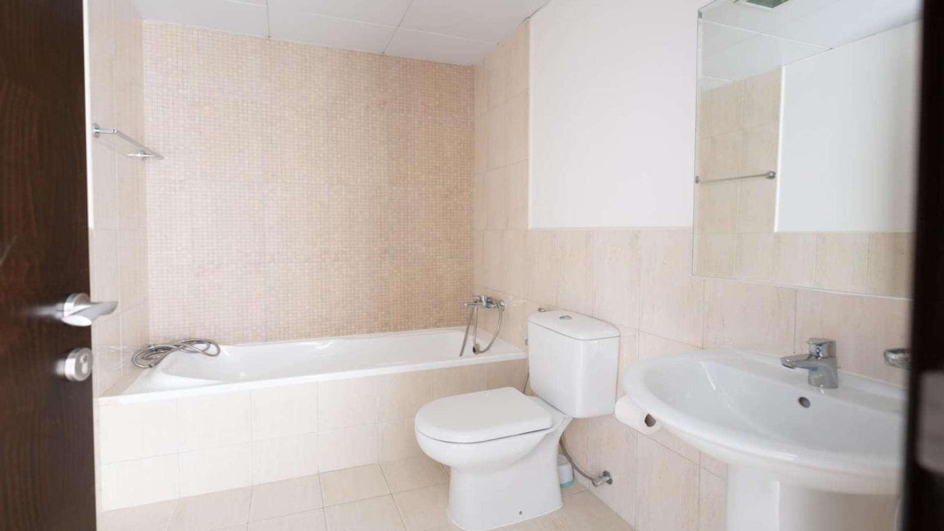 Modern kitchen in spacious 2-bedroom apartment for rent, JVC, with dark wood cabinets