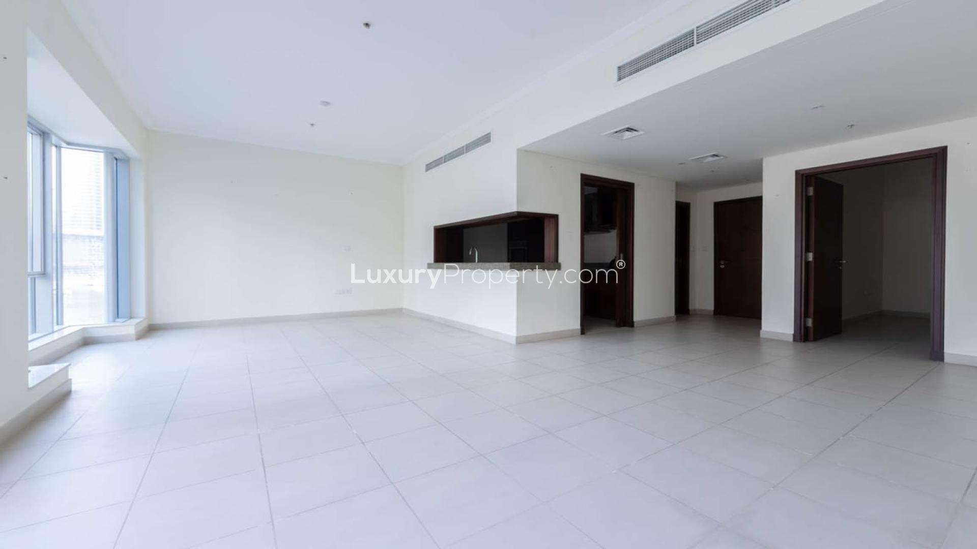 Spacious living room with large windows, offering marina views in Dubai Marina apartment