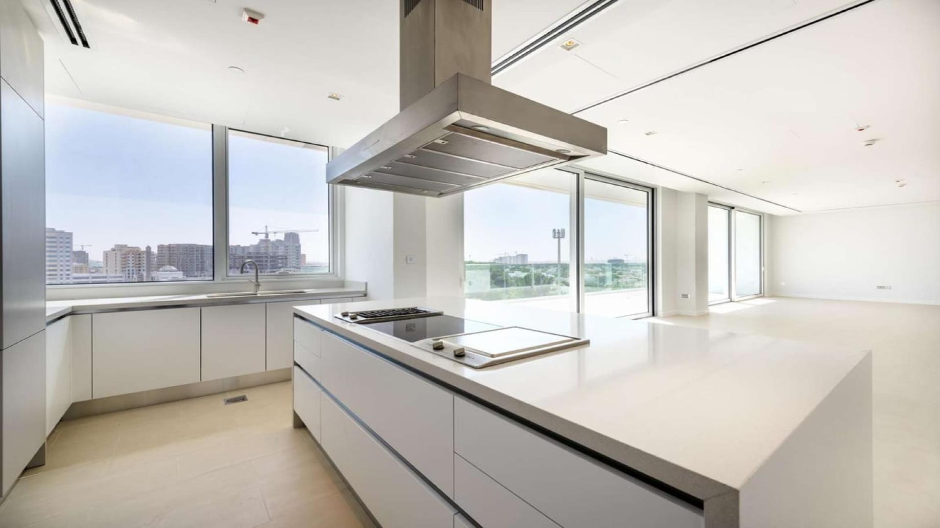 Modern kitchen with island in luxury apartment, Seventh Heaven, Al Barari, garden views