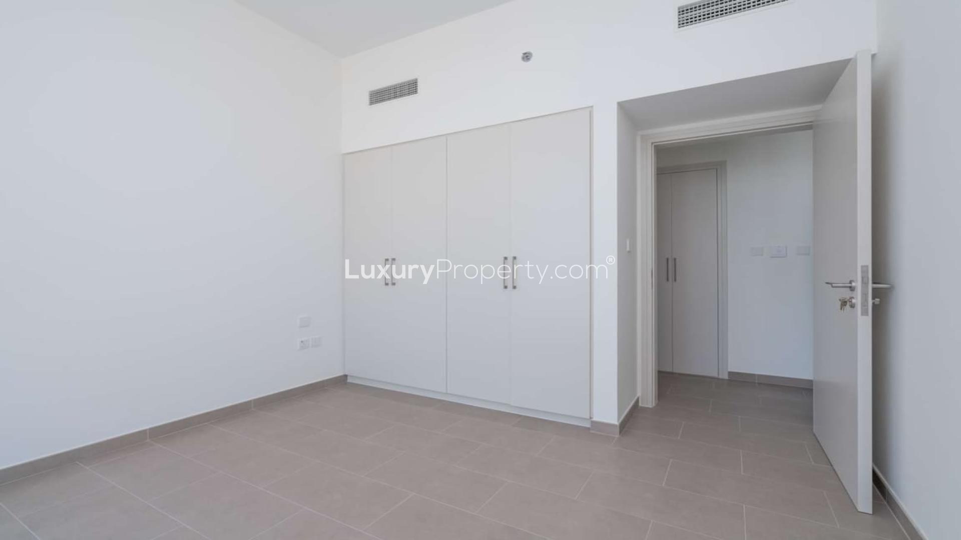 High-floor apartment interior with balcony and skyline views in Dubai Hills Estate