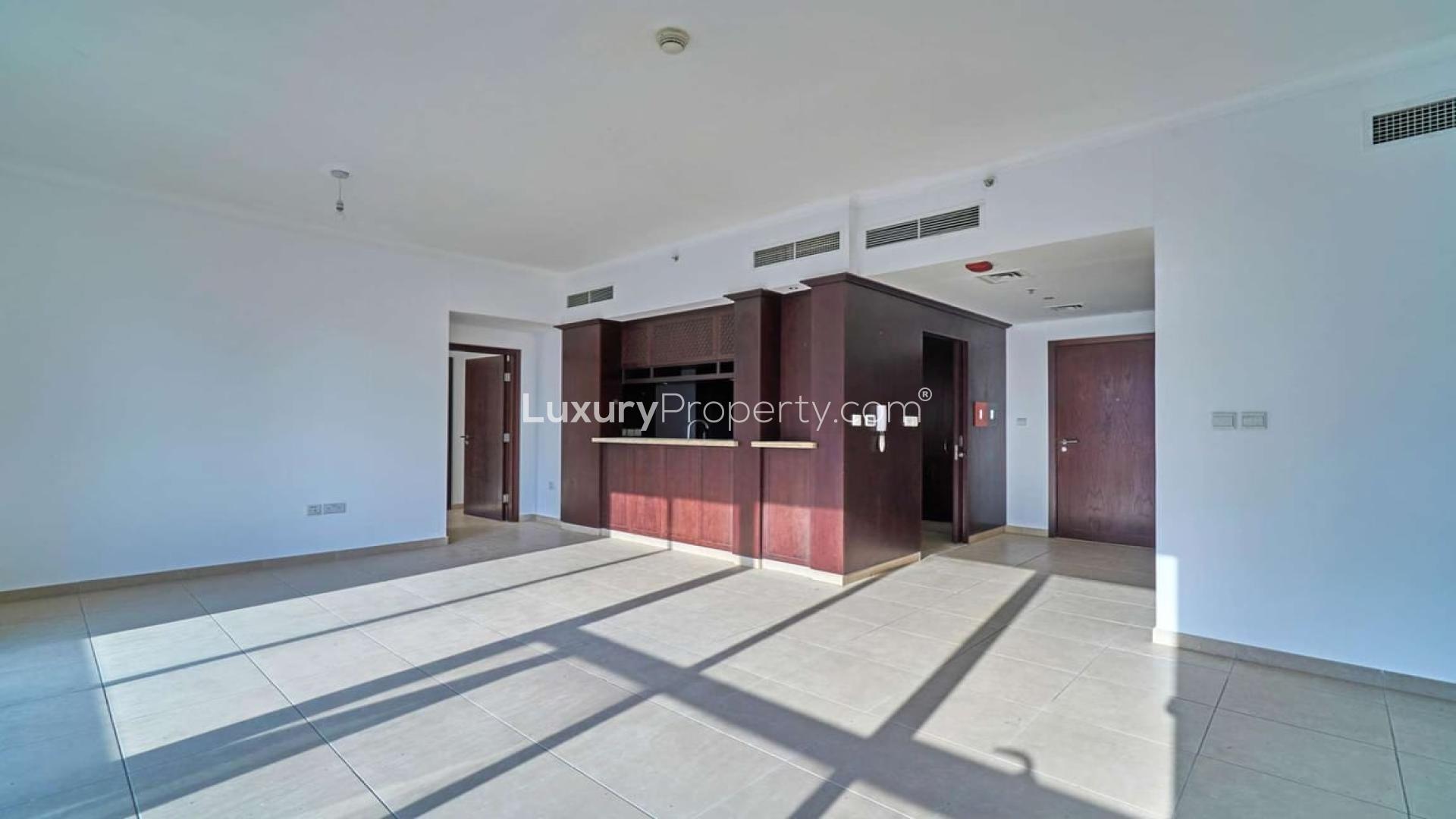 Spacious living area in Downtown Dubai apartment with modern kitchen and large windows