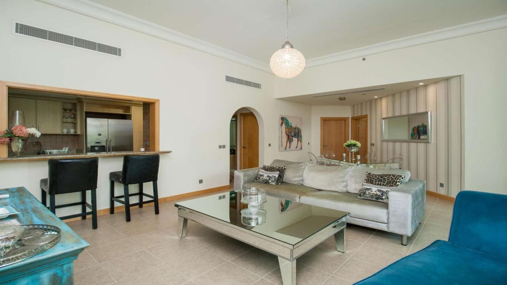 Elegant living room in Shoreline Residences apartment, Palm Jumeirah, featuring modern decor and open kitchen