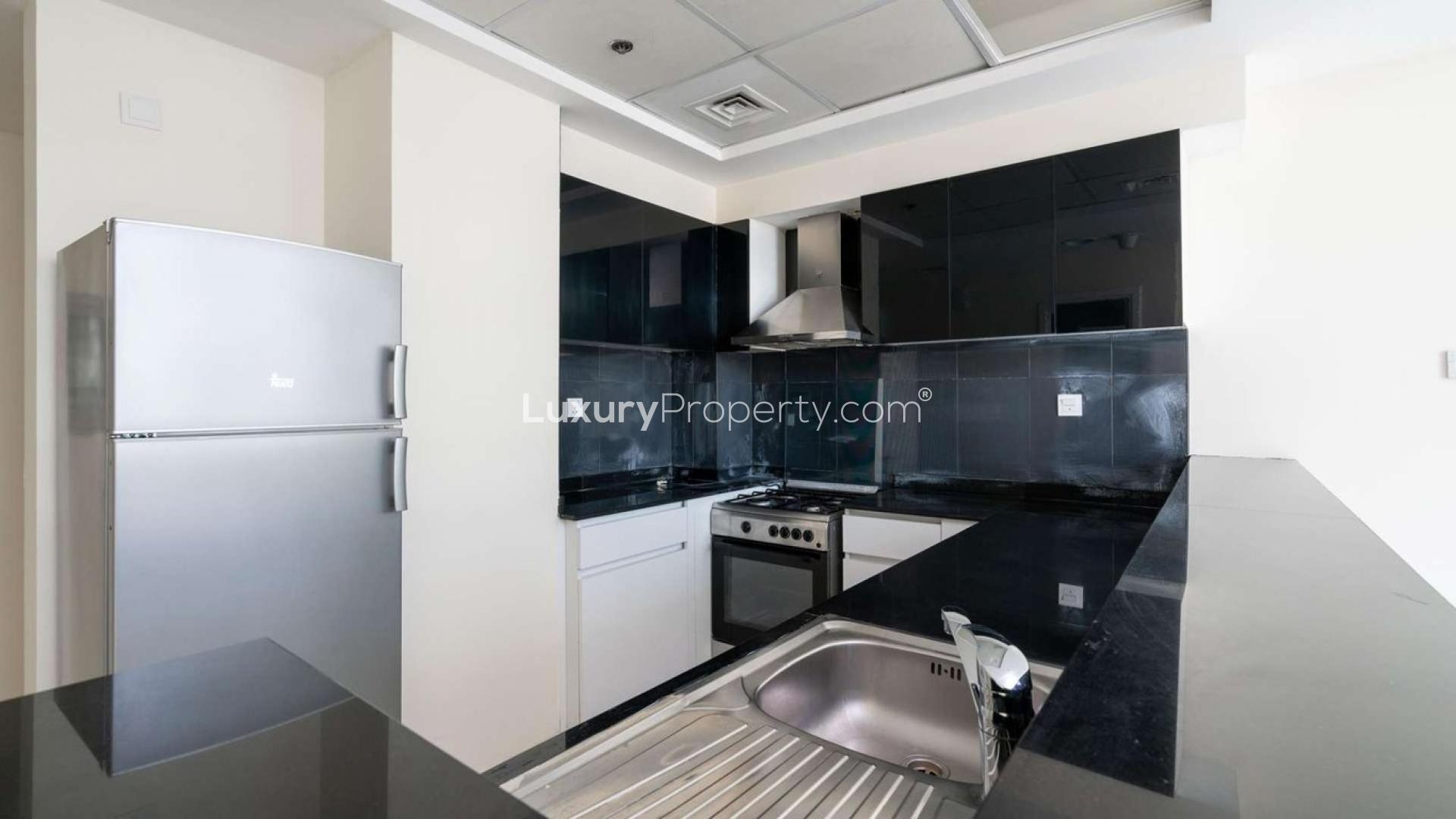 Bright bedroom with large windows and built-in wardrobe in Park Central, Business Bay apartment