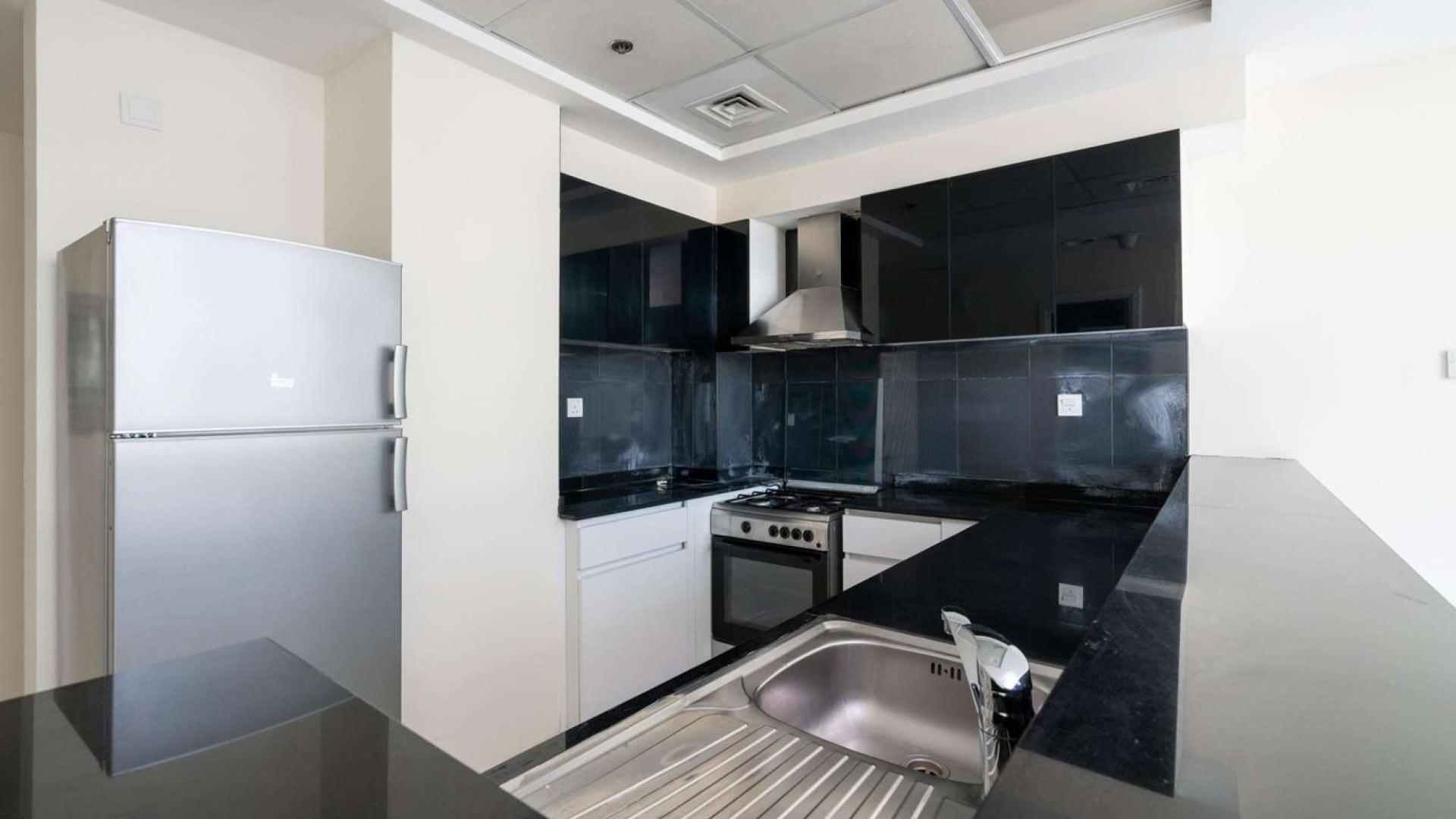 Bright bedroom with large windows and built-in wardrobe in Park Central, Business Bay apartment