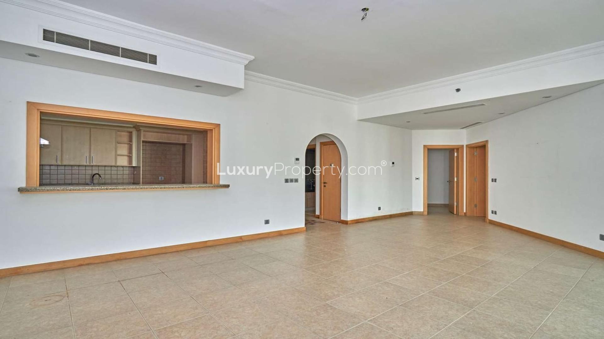 Spacious living room in Shoreline Apartment, Palm Jumeirah, with large windows and tiled floor