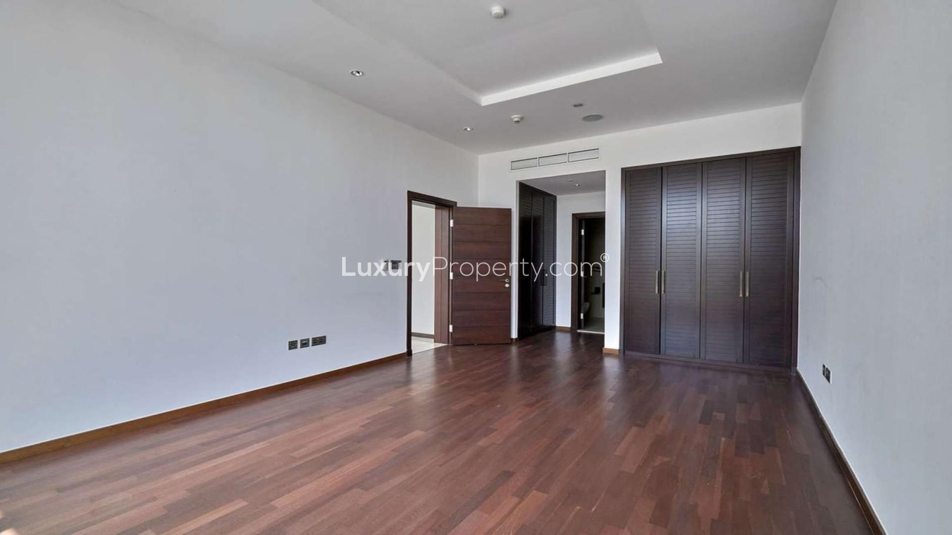 Spacious living room in Tiara Residences apartment, Palm Jumeirah, with large windows and balcony