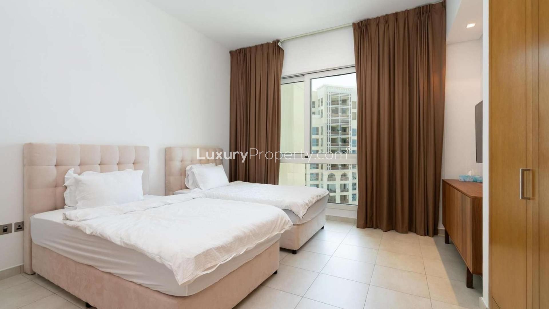 Furnished bedroom in Palm Jumeirah apartment, Marina Residences, with twin beds and window view